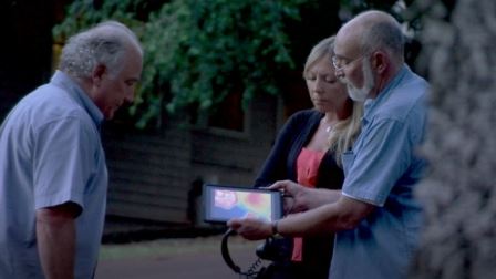 Three People Watching a Screen
